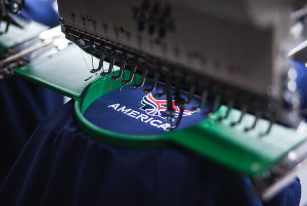 # **Embroidered Apparel for Business: Why It Matters and How to Do It Right** For businesses across the Chicago area and beyond, embroidered apparel isn’t just a wardrobe choice—it’s a brand asset. Whether you’re outfitting employees, preparing promotional giveaways, or standardizing uniforms, embroidery offers a polished, professional appearance that reinforces your company’s identity. In this guide, we’ll explore the benefits of **embroidered apparel for business**, what to consider when selecting garments and designs, and how to ensure a final product that reflects your organization’s values. ### Why Choose Embroidery for Business Apparel? Embroidery is one of the most durable and versatile branding methods available for garments. Here’s why so many organizations rely on it: - **Professional look:** Embroidery creates a high-end finish that elevates brand perception. - **Durability:** Embroidered logos don’t fade, crack, or peel like some print methods. - **Long-term value:** With proper care, embroidered items maintain their appearance for years. - **Versatility:** Suitable for polos, button-downs, jackets, hats, bags, and more. Whether you're in healthcare, hospitality, construction, education, or corporate services, embroidery communicates consistency and attention to detail. ## **Ideal Apparel Types for Embroidery** Certain garments work especially well for embroidery. These are the most popular options businesses choose: ### **Polos and Button-Down Shirts** Perfect for front desk staff, sales teams, and customer-facing employees. Embroidered logos over the left chest remain a corporate standard. ### **Outerwear** Quarter-zips, vests, and jackets offer large canvas areas for branding and are ideal for year-round use in the Midwest. ### **Hats and Headwear** A budget-friendly item for team recognition, event giveaways, or employee appreciation gifts. Embroidery adds perceived value to caps. ### **Tote Bags and Accessories** Embroidered tote bags, laptop sleeves, or duffle bags offer high utility and long-lasting exposure for your brand. ## Embroidery Placement: Strategic and Stylish Choosing the right placement for embroidery enhances visibility while maintaining a professional appearance. Standard locations include: - **Left chest** (most common for polos and button-downs) - **Sleeves** (ideal for certifications, slogans, or secondary logos) - **Upper back** (great for jackets and hoodies) - **Cap front or side** (for compact, clean logos) - **Bag panels** (centered or top corner embroidery) Make sure your logo size and complexity match the available space and fabric type. ## Tips for Choosing a Garment Vendor When selecting a vendor for embroidered apparel, consider the following: - **In-house embroidery capabilities** – Look for a shop with direct control over quality and timelines. - **Design assistance** – Some vendors offer digitizing and logo setup support to ensure your design stitches well. - **Apparel options** – A wide selection of brands, sizes, and styles ensures you get what’s right for your team. - **Customer service** – Clear communication and reliable timelines are essential, especially for onboarding or reorders. At State Graphics, we manage embroidery production on-site and work closely with clients to ensure brand accuracy, comfort, and long-term value. ## Embroidery Best Practices for Businesses To get the most from your embroidered apparel program, keep these practices in mind: ### **Keep it Simple** Complex gradients or tiny text may not translate well in stitches. Stick with bold, clear designs for best results. ### **Use Brand Colors** If your brand guidelines include Pantone colors, be sure to communicate them. Your vendor can match thread colors closely. ### **Choose Quality Fabrics** Embroidery looks and lasts better on mid- to heavyweight fabrics. Thinner materials may pucker or distort the stitching. ### **Order Extras** Maintain a small surplus of standard sizes to cover new hires or replacements. This prevents delays and keeps your team uniform. ## Budget Considerations Embroidery pricing depends on: - **Stitch count** – More stitches = more time and cost - **Garment type** – Jackets and specialty items cost more than basic tees - **Order size** – Larger quantities often receive price breaks - **Number of locations** – Each embroidered area (e.g., chest and sleeve) adds to the cost Plan your order based on usage. For example, you may invest more in client-facing uniforms than internal staff apparel. ## Final Thoughts **Embroidered apparel for business** is more than a uniform—it's a strategic branding decision. From enhancing professionalism to increasing visibility, embroidery is a smart long-term investment for your organization. Whether you're launching a new branding initiative or refining your current program, working with an experienced embroidery partner ensures your garments look great, wear well, and represent your brand with pride. **Looking to get started?** Contact State Graphics for personalized recommendations, samples, and quotes tailored to your business needs.